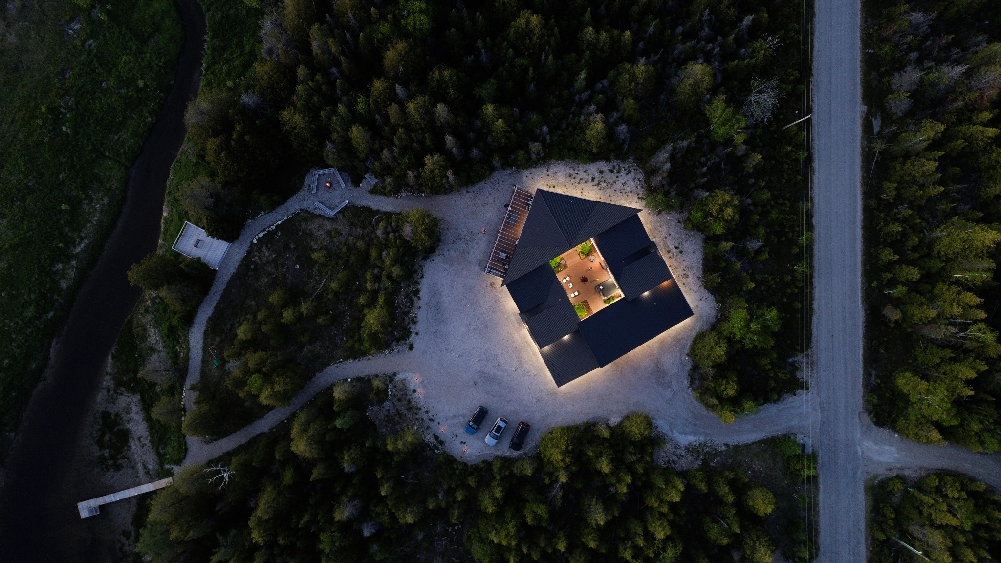 Aerial evening view of Pentagon Courtyard Escape surrounded by forest