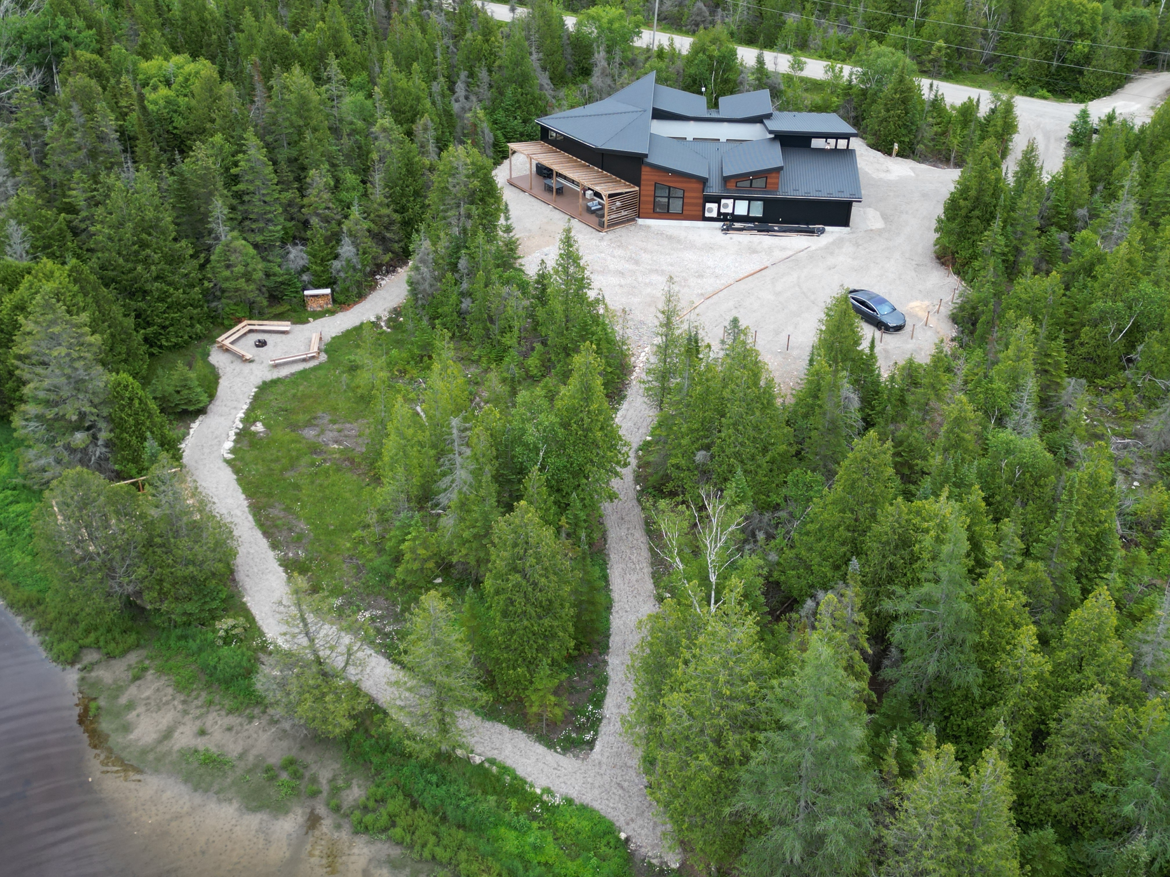 Aerial view of the cottage surrounded by forest