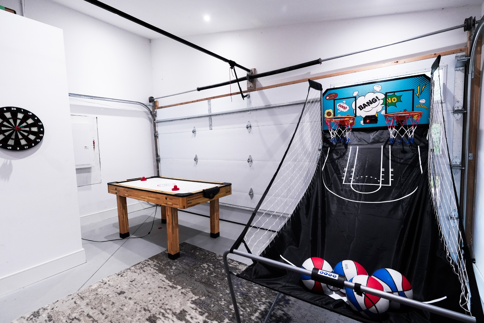 Games room with foosball, darts and indoor basketball